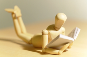 wooden-figure-reading-book